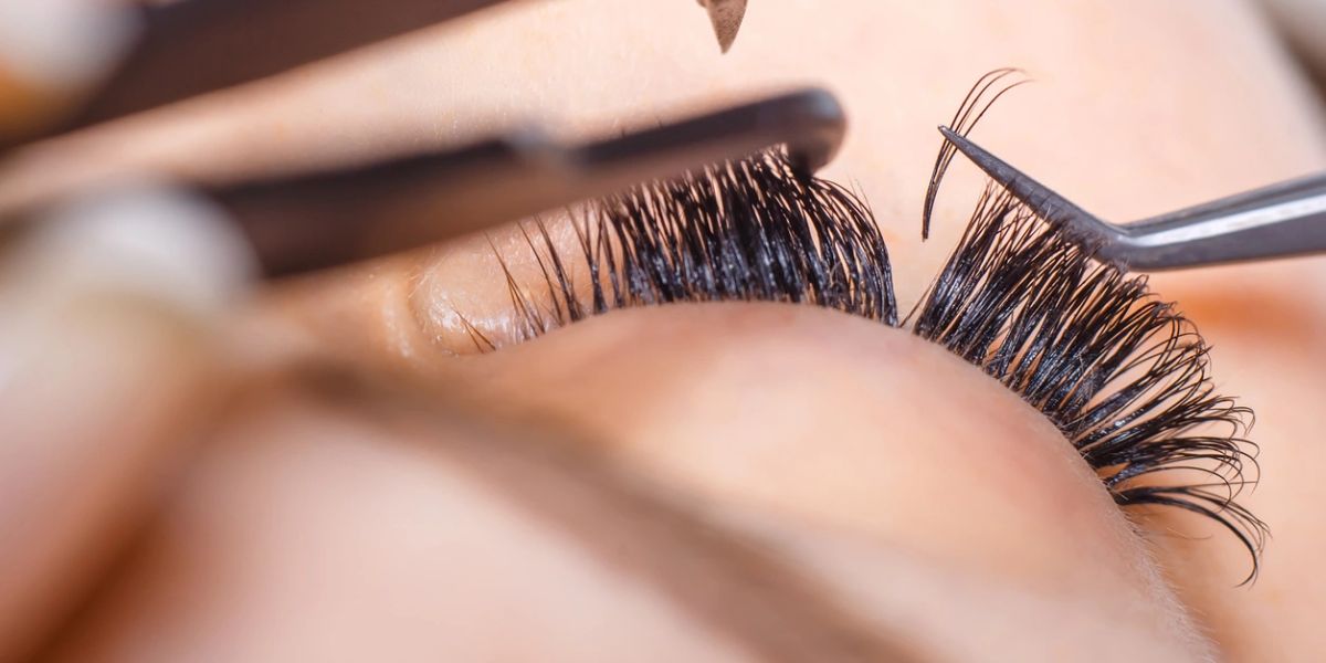 Close-up of professional eyelash extension application.